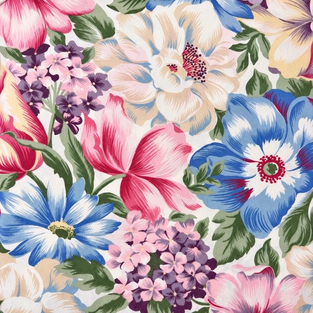 Large pink, blue, cream, and purple flowers with green leaves.